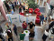 A group of people are gathered in a bright indoor atrium for a professional event or conference. A group of people are gathered in a bright indoor atrium for a professional event or conference.